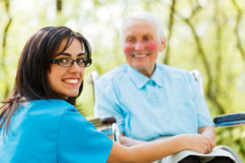 smiling old caregiver and elderly woman